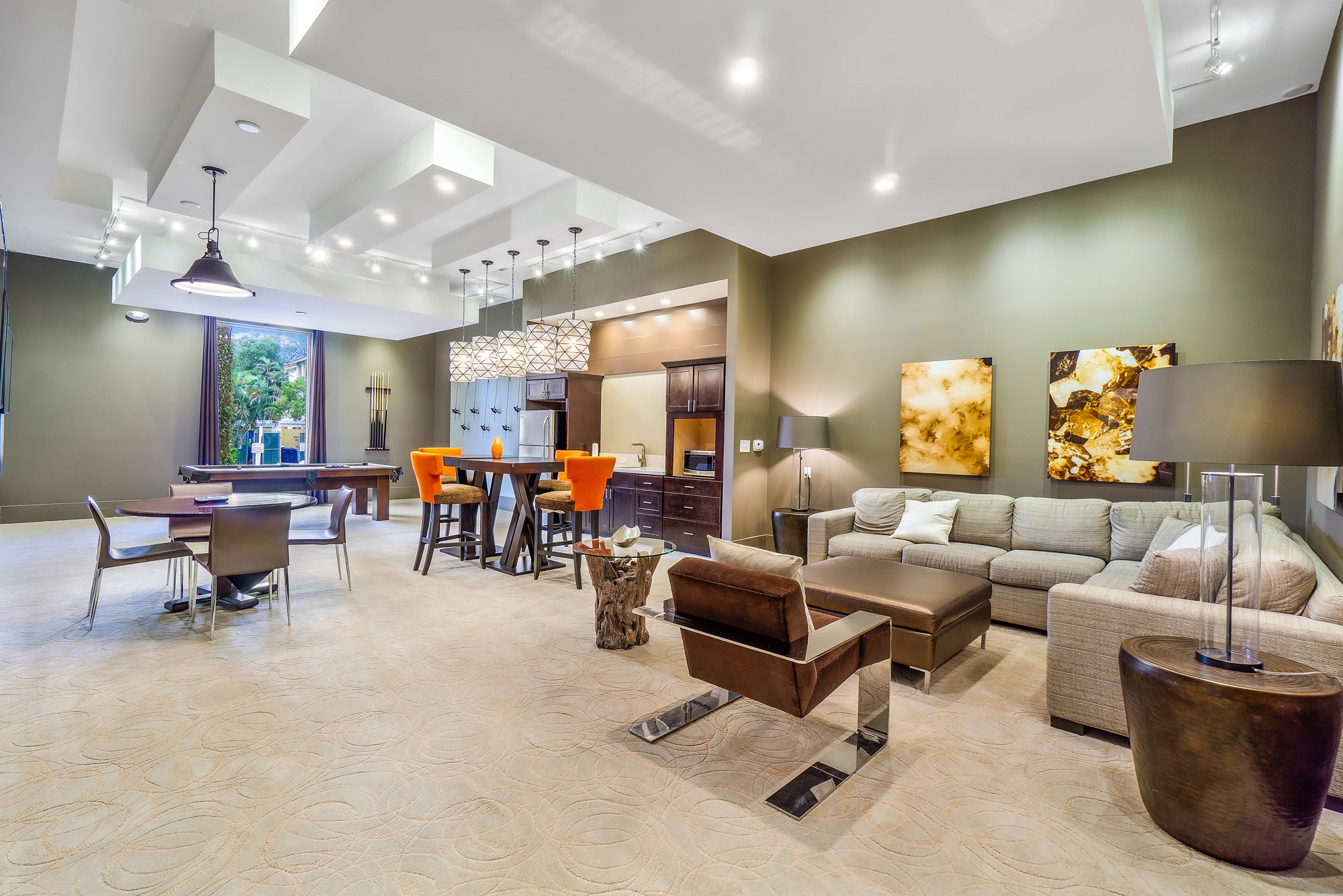 A spacious living room with a variety of furniture and decorative elements.